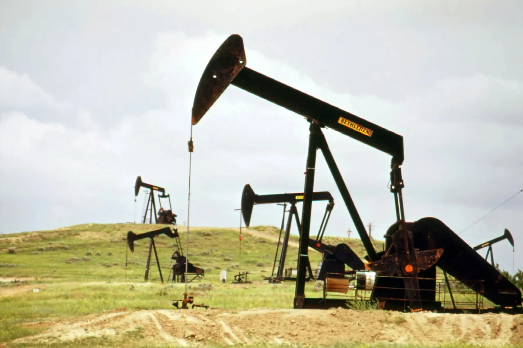 Pumpjacks working an oil field under an open sky