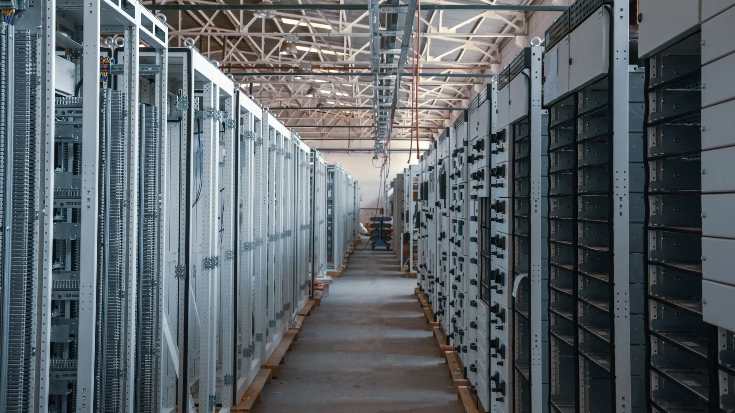 Long aisle between server racks in a data center hall
